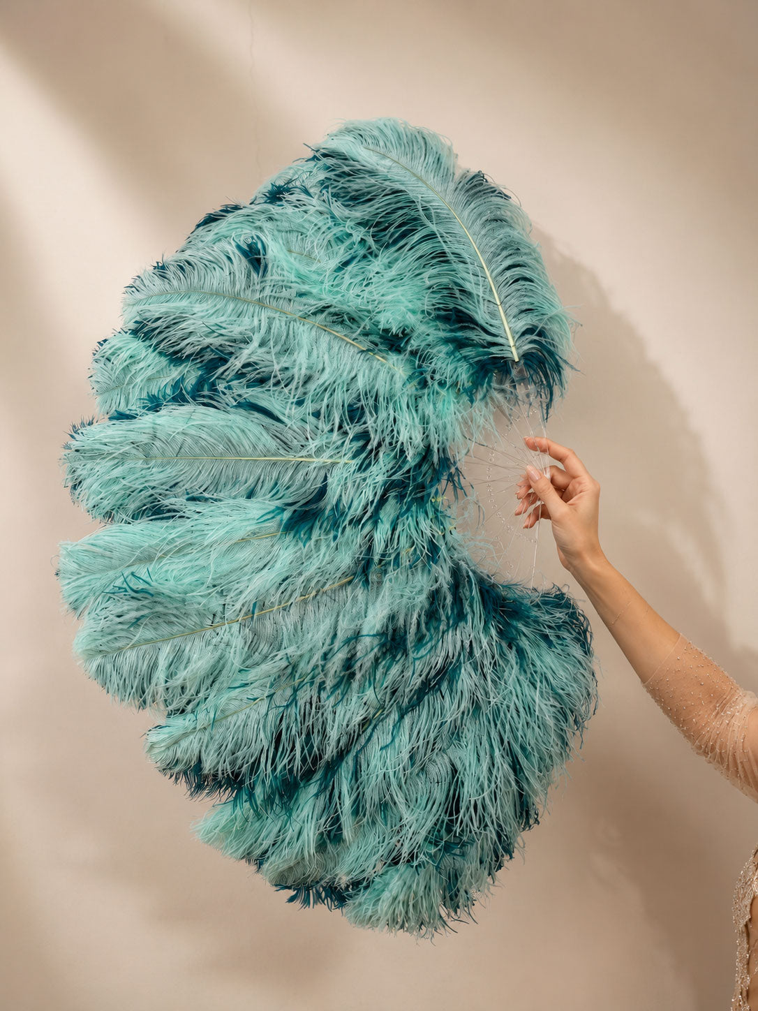 Close-up of BurlyLuxe Single Layer Beginner's Double-Sided Stage Ostrich Feather Fan 25" × 47" showing feather texture and fan shape.